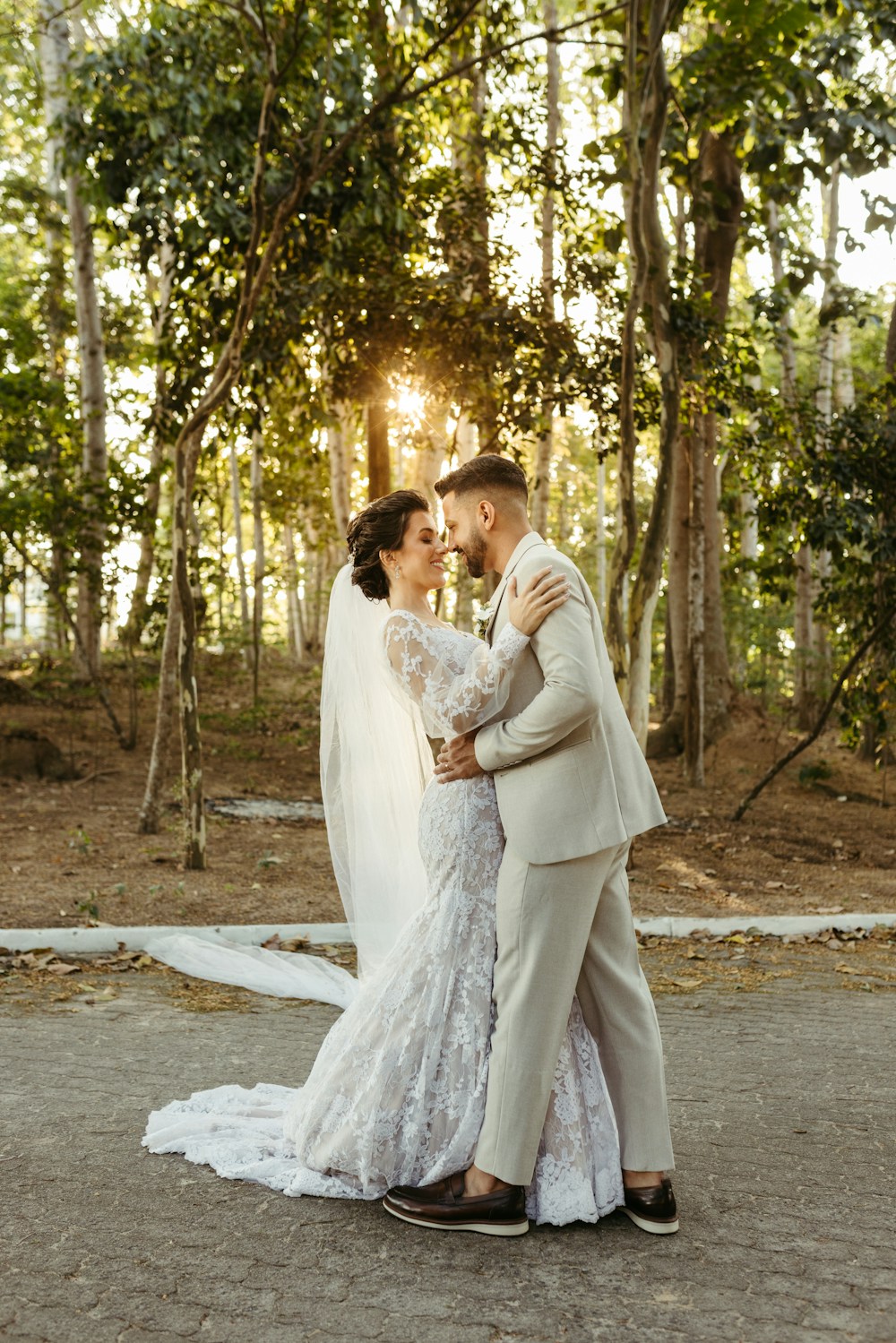 A bride and groom embracing outdoors